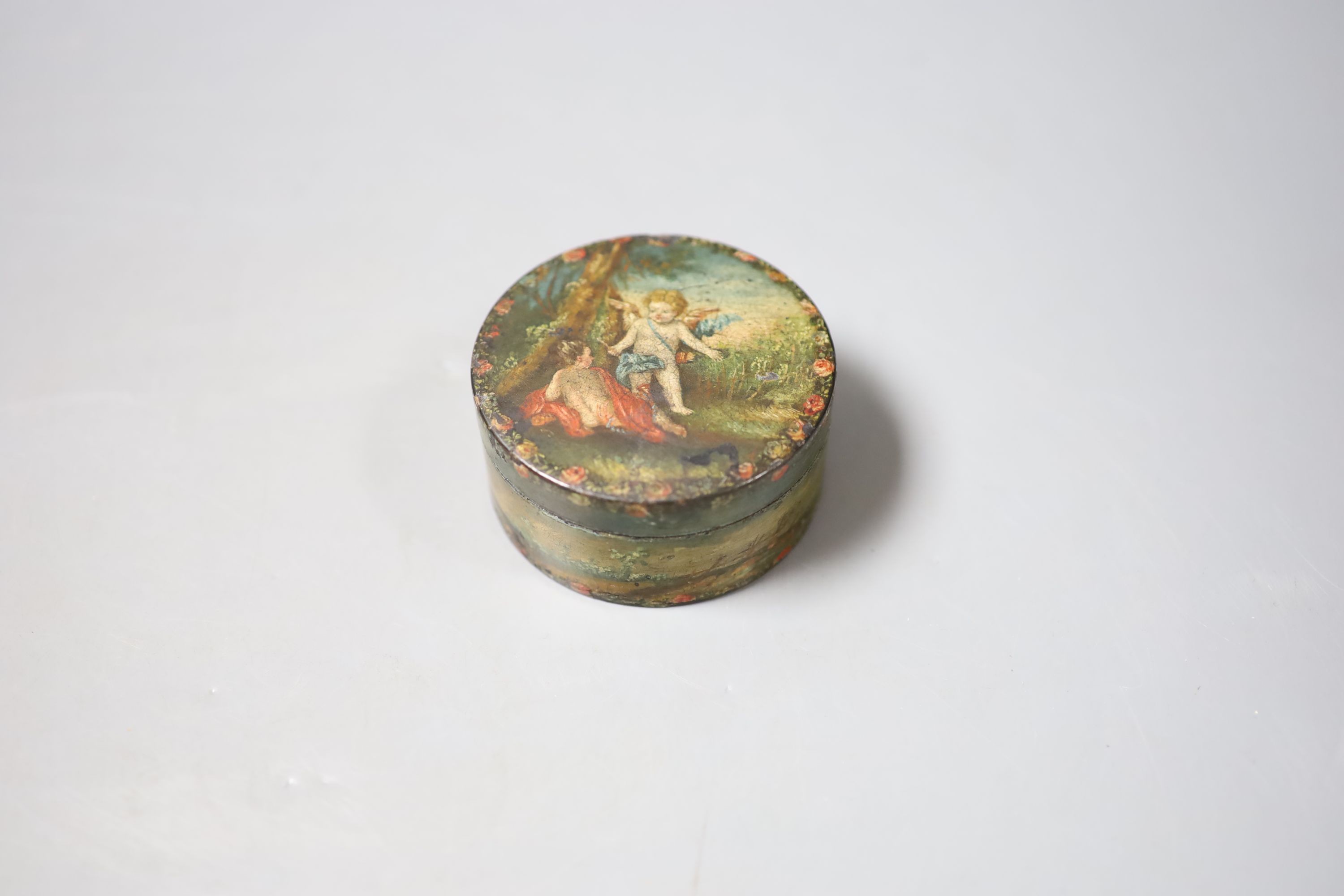 A 19th century circular papier mache box and cover decorated with cherubs and a compass from a library globe, diameter 14cm